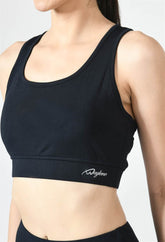 Close-up of Waylene navy blue sports bra showing racerback design and stretchable straps front view